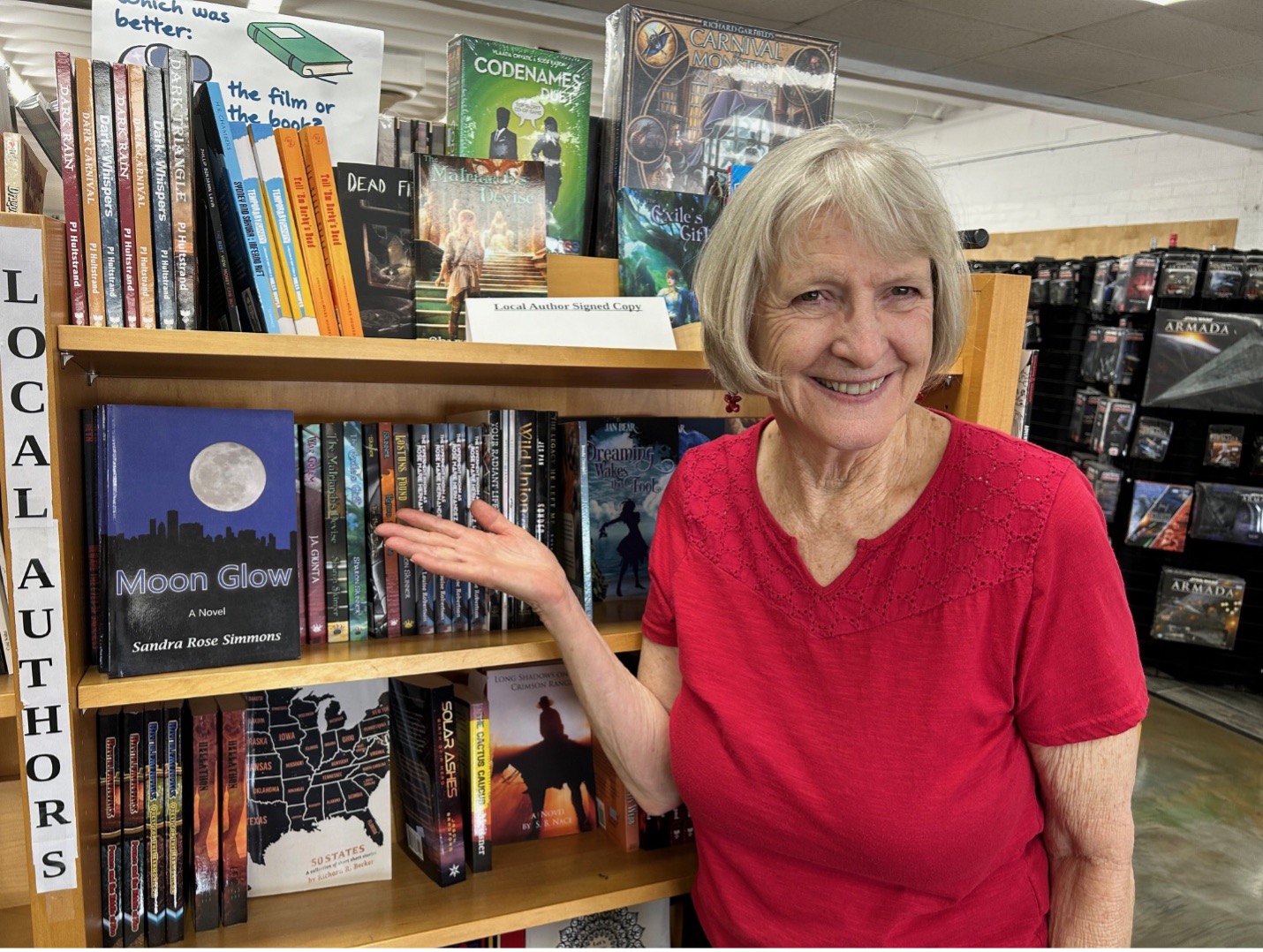 Author Sandra Rose Simmons with her novel Moon Glow at Bookmaze bookstore in Mesa, Arizona